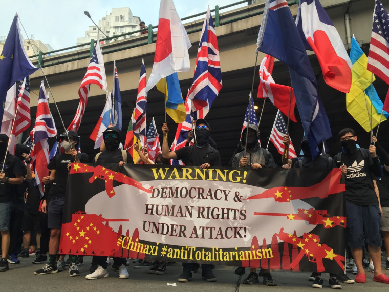 Protesters in Hong Kong marched Sunday with a banner denouncing what they claim is "Chinese totalitarianism."