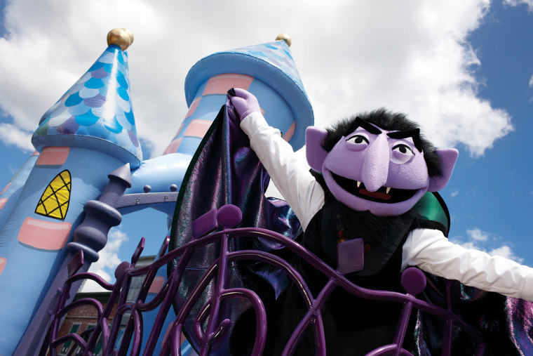Count von Count and friends roam through the streets in their Halloween costumes during the parade through Sesame Street Land.