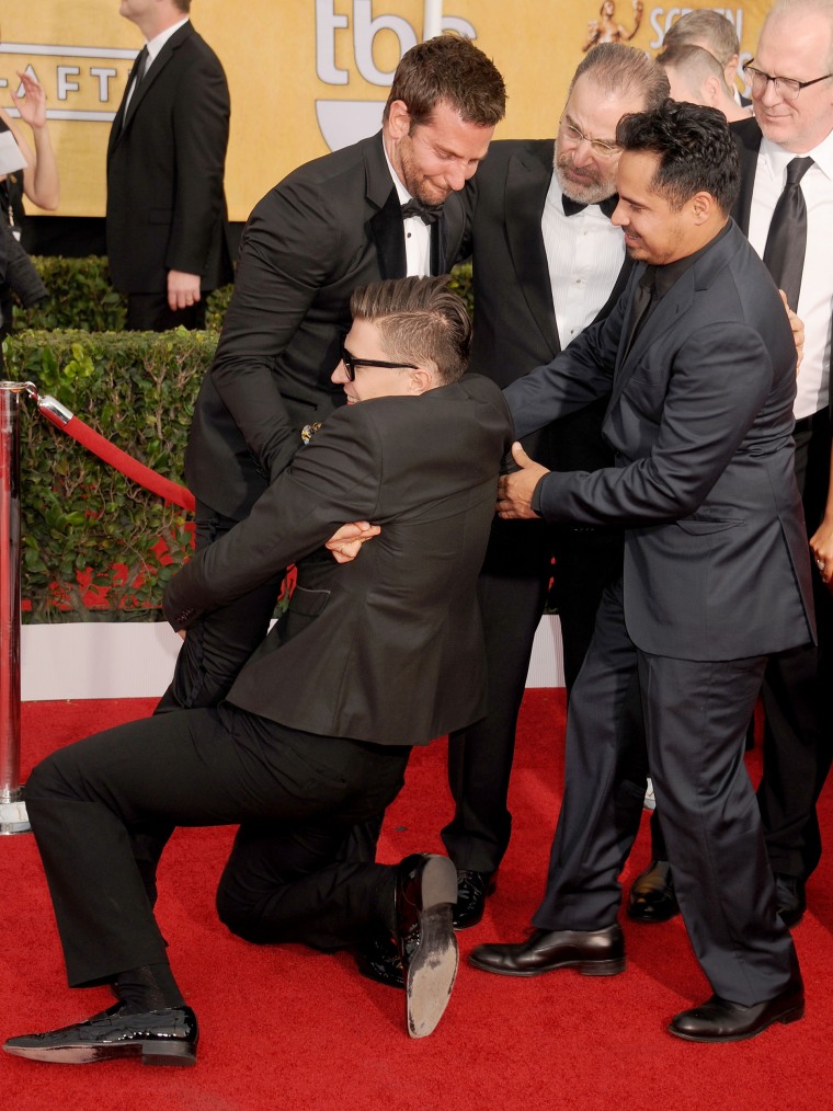 Justin Timberlake is TACKLED by a man who grabs his leg after he arrived to Louis  Vuitton show