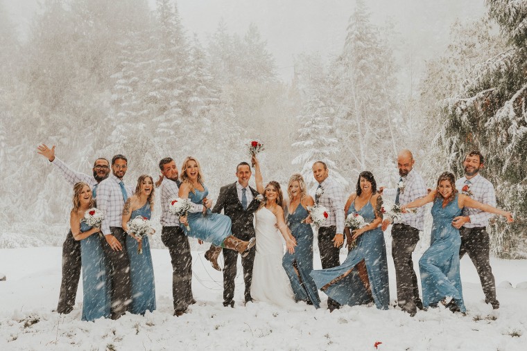 Newlyweds pose for wedding photos in snowstorm
