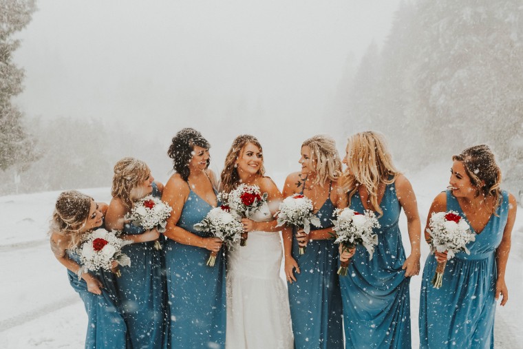 Newlyweds pose for wedding photos in snowstorm