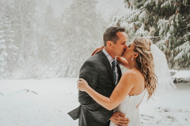 Newlyweds pose for wedding photos in snowstorm