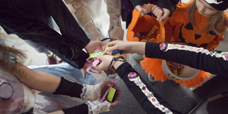Group of children trick or treating for sweets on Halloween