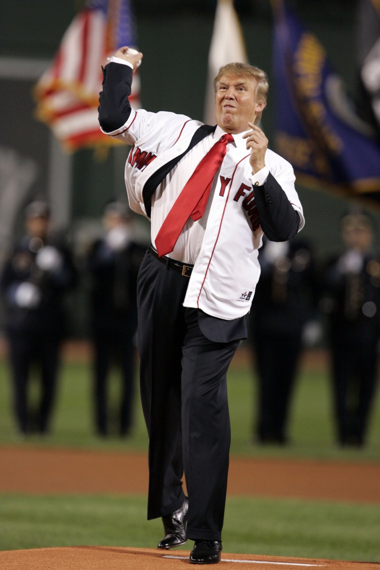 Image: Trump throws the first pitch before the start of the second game between the Boston Red Sox and New York Yankees