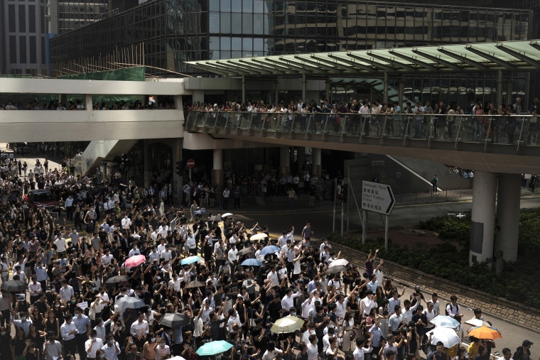 Image: Anti-government protesters march at Central district in Hong Kong,