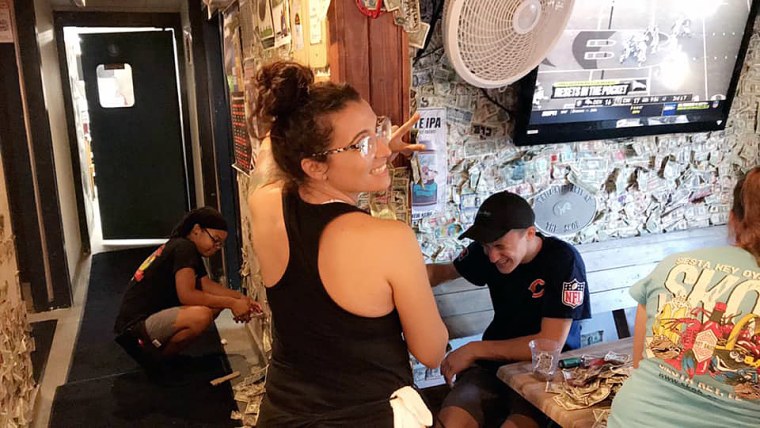 About 40 staff members at Siesta Key Oyster Bar spent the month of September carefully removing dollar bills from the restaurant's walls and ceiling to donate to Hurricane Dorian relief efforts. The total came out to $13,961, according to General Manager Kristin Hale.