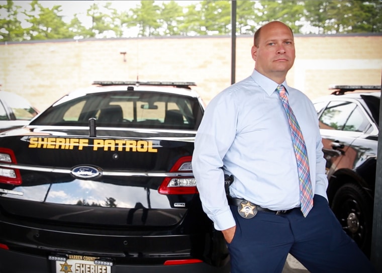 Jim Banish, 43, stands in the parking lot of the Warren County Sheriff's Office in Lake George, NY. Banish has devoted himself to helping police officers who are struggling with mental health conditions. "If a cop needs help, I'll do anything I can to be there for them," he said.
