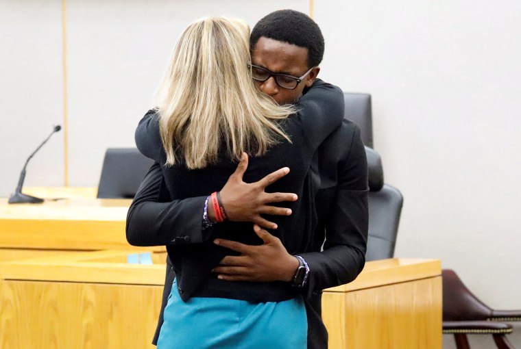 Image: Botham Jean's younger brother Brandt Jean hugs former Dallas police officer Amber Guyger