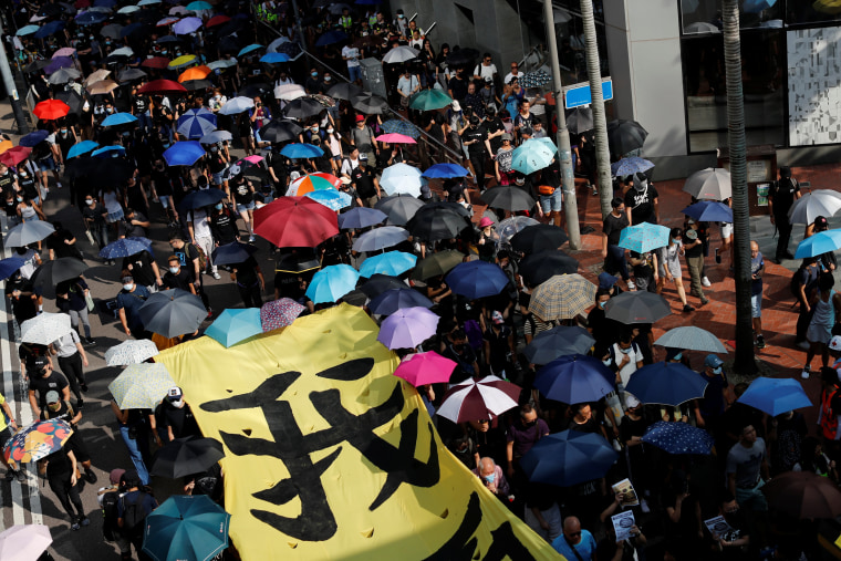 Image: Anti-government protesters march in a protest in central Hong Kong