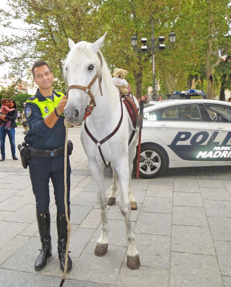 Fuzzy hanging out with a police officer on the streets of Spain.