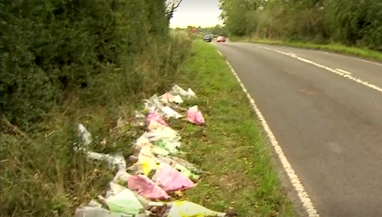Image: Flowers on the side of the site of a fatal crash in Northamptonshire, England.