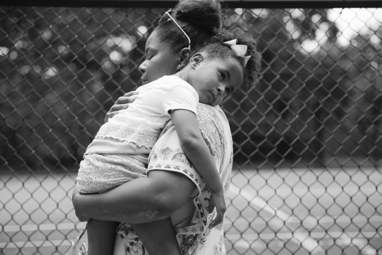 Ajshay James holds her daughter, Harper, at the end of a visit in July 2019.