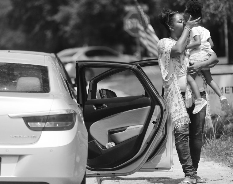 Ajshay James kisses her daughter before they drive back to Harper's paternal grandparents' home after a visit in July 2019.
