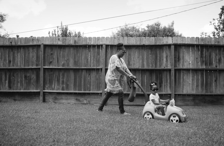 James pushes her daughter in a toy car during a visitation on July 6, 2019.