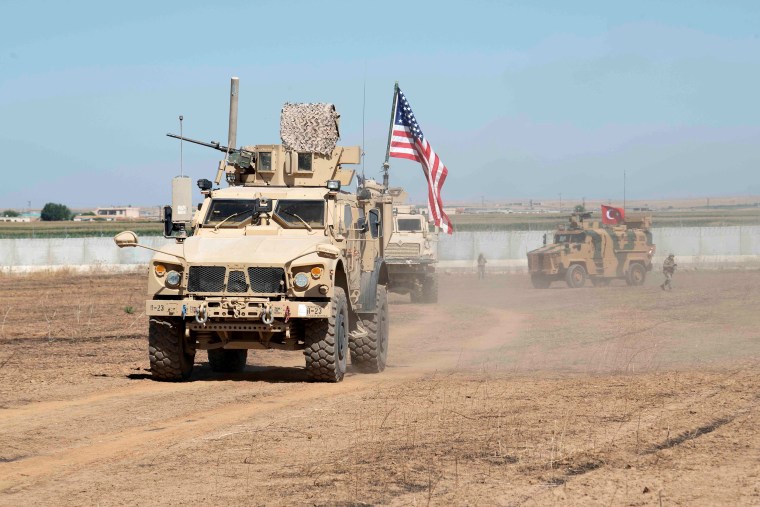 Image: U.S. and Turkish military forces conduct a joint ground patrol in northeast Syria