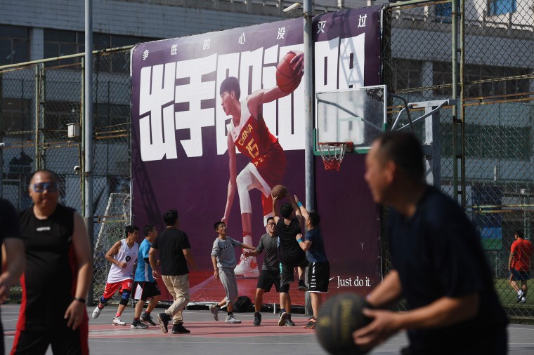 Image: People play basketball at an outdoor court in Beijing on Oct. 9, 2019.