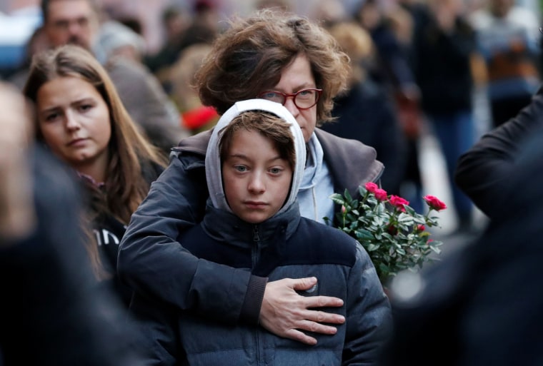 Image: People mourn outside the synagogue in Halle, Germany, Oct. 10, 2019, after two people were killed in a shooting.