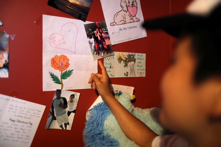 Image: Marveny Suchite, a Guatemalan asylum-seeker, shows photos of her family on the wall of her home in Berkeley, Calif., on Sept. 6, 2019.