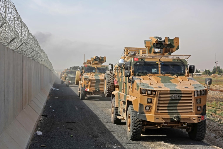 Turkish armored vehicles drive along the Turkish side of the border as they prepare to take part in an offensive against Kurdish-controlled areas in northeastern Syria on Oct. 11, 2019.
