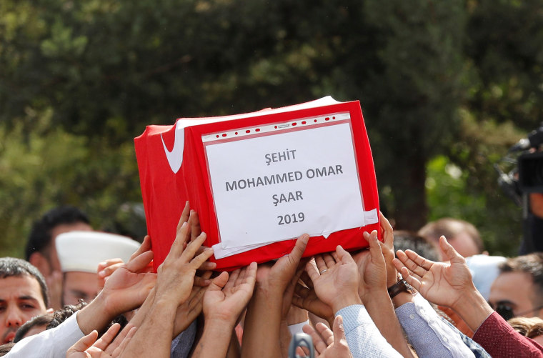 Image: People carry the Turkish flag-wrapped coffin of 9-month-old baby boy 