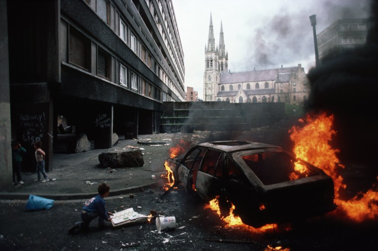 Image: Boys mill around a car they have just set on fire in Belfast in 1988.