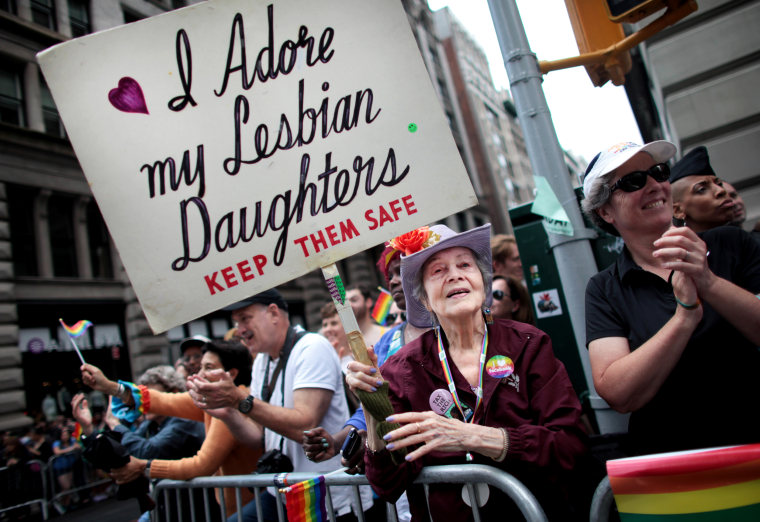 Image: Frances Goldin holds a sign in support of her two lesbian daughters at New York's Pride Parade in 2015.