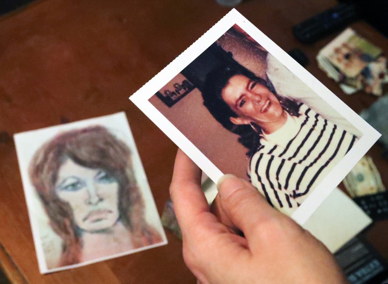 Image: Tonya Maslar holds a photographer of her mother, Roberta Tandarich, on Oct. 10, 2019. A sketch of Tandarich drawn by serial killer Samuel Little, who claims she was one of his many victims, lies on the table.