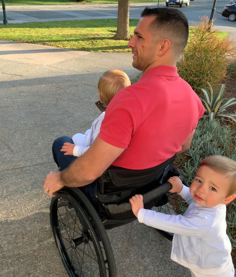 Derek Herrera in wheelchair with his 2-year-old twin boys, Hunter and Hudson