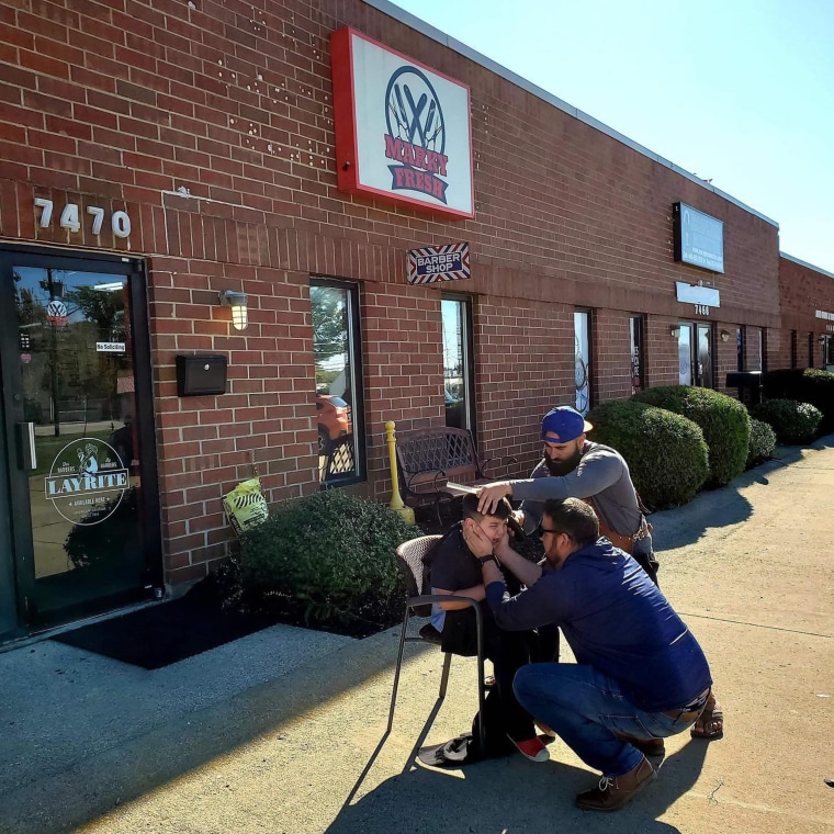 Marco Conti gives Brycen Juby a haircut outside in order to help him feel more comfortable.