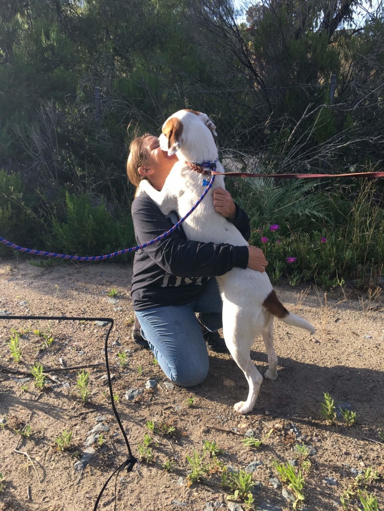 Babs Fry hugs a dog named Lilah.