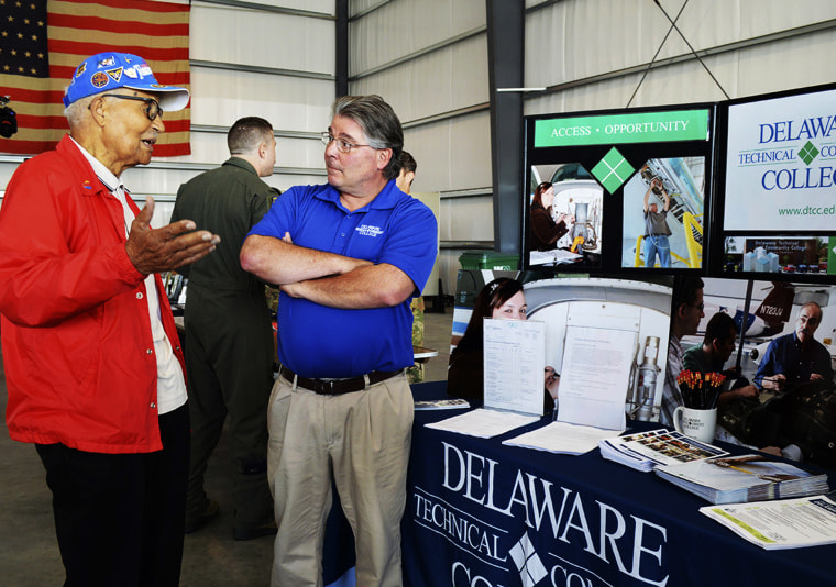 Image: Retired Col. Charles McGee, left, chats with Jeff Visalli, admission and recruitment counselor for Delaware Technical Community College, during a Pathways to Aviation Day in Georgetown in August 2019.