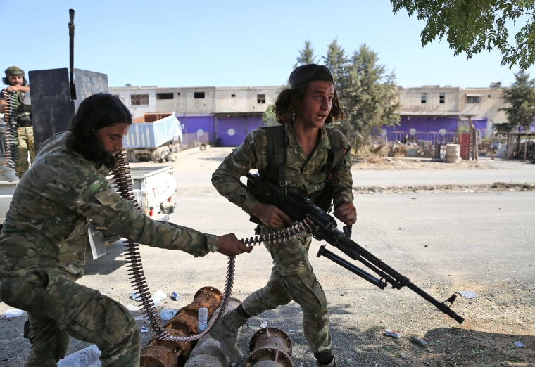 Image: Turkish-backed Syrian fighters take part in a battle in Syria's northeastern town of Ras al-Ain in the Hasakeh province along the Turkish border as Turkey and its allies continue their assault on Kurdish-held border towns in northeastern Syria