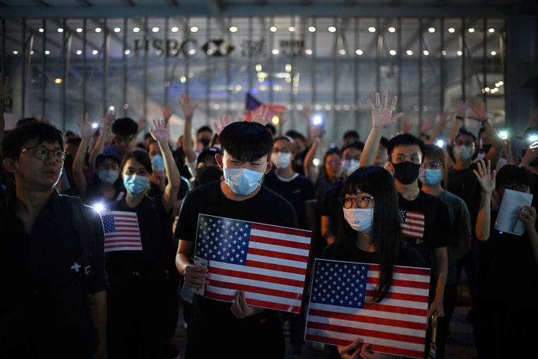 Image: Protesters chant slogans as they attend a rally in Hong Kong