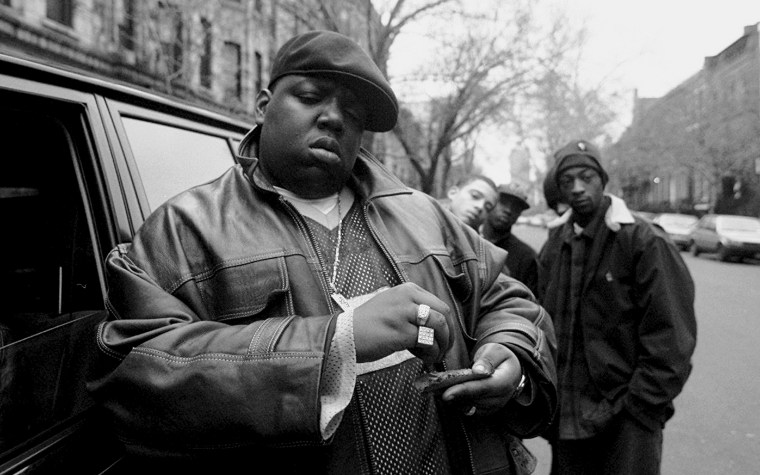 Image: Notorious B.I.G rolls a cigar in Brooklyn in 1995.