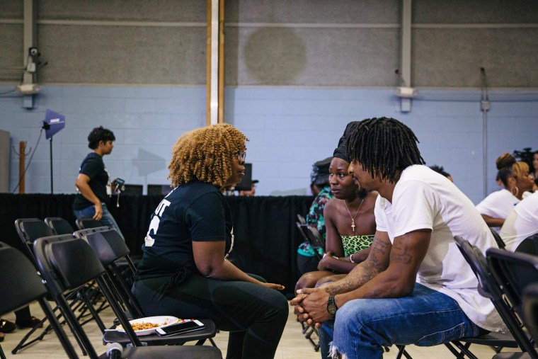 LaTosha Brown speaks with Flint residents during a Democratic Debate watch party.