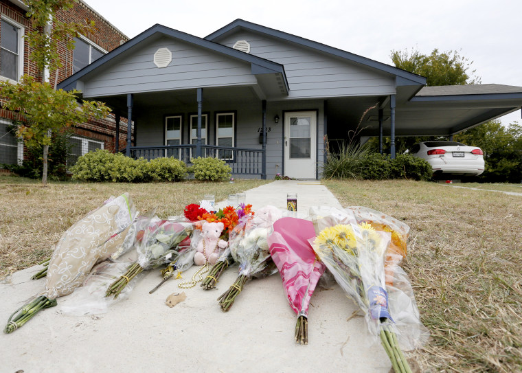 Flowers lie on the sidewalk in front of the house in Fort Worth, Texas on Oct. 14, 2019, where a white Fort Worth police officer shot and killed Atatiana Jefferson, a black woman, through a back window of her home.