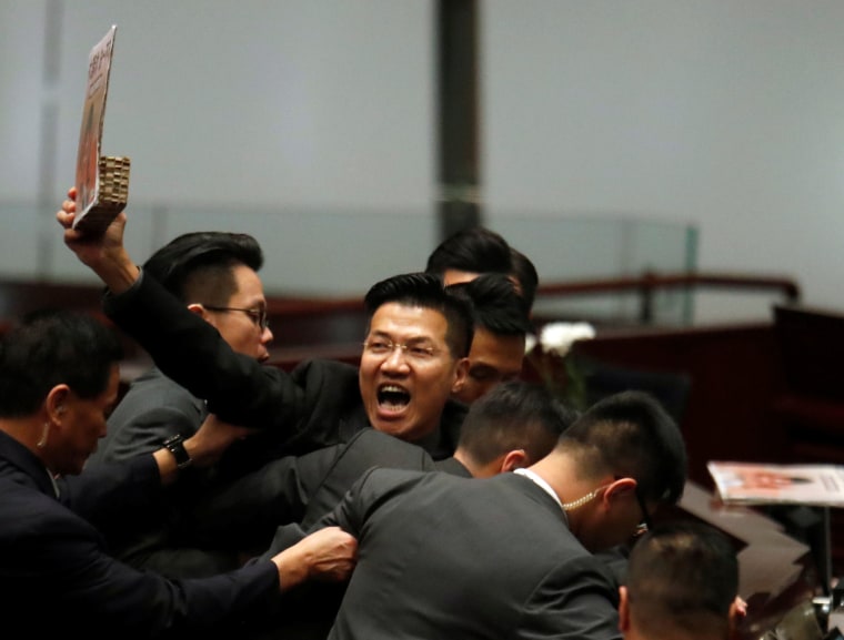 Image: A pro-democracy lawmaker is escorted by security from the Legislative Council, as Hong Kong's Chief Executive Carrie Lam takes questions from lawmakers regarding her policy address, in Hong Kong, China