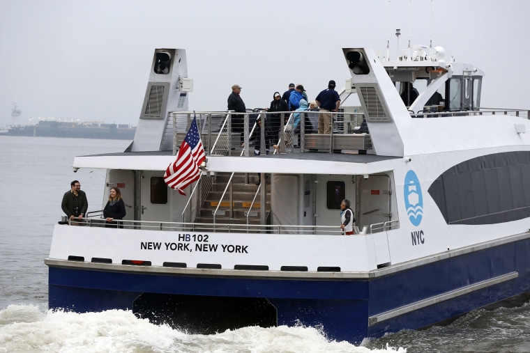 Image: Passengers on board a NYC Ferry watch as the boat departs Sunset Park, Brooklyn for Rockaway, Queens.