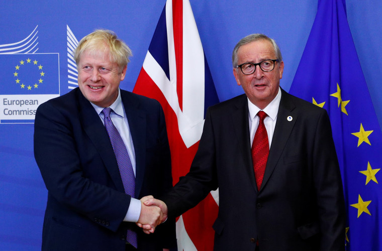 Image: European Commission President Jean-Claude Juncker and Britain's Prime Minister Boris Johnson shake hands during a news conference after agreeing on the Brexit deal