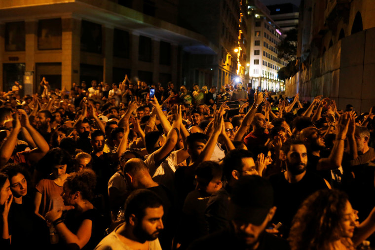 Image: People gesture during a protest over deteriorating economic situation in Beirut