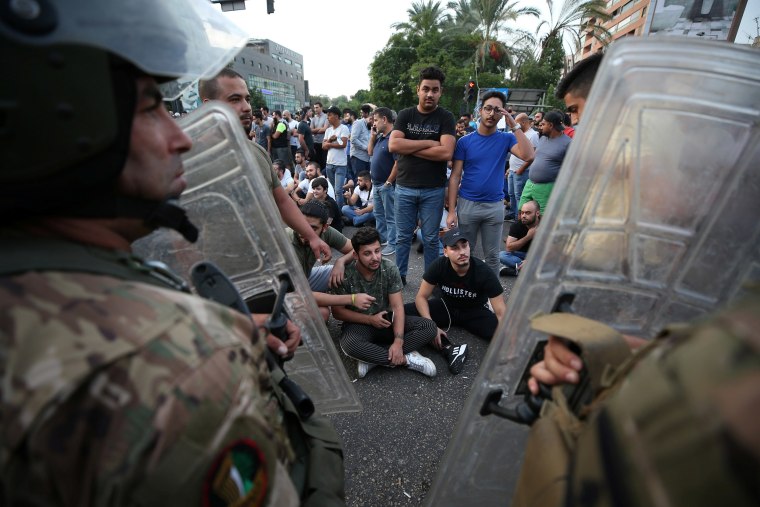 Image: Demonstrators gather during a protest over deteriorating economic situation, in the port city of Sidon, Lebanon