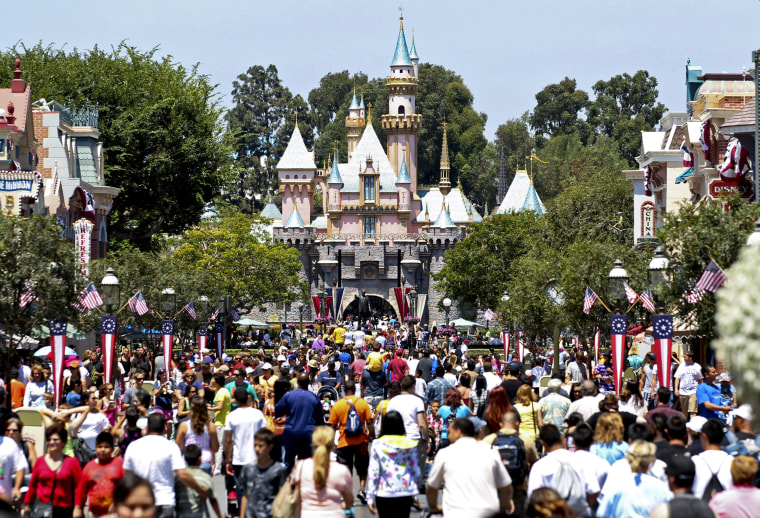 Image: Patrons walk in front of Sleeping Beauty Castle at Walt Disney Co.'s Disneyland amusement park in Anaheim