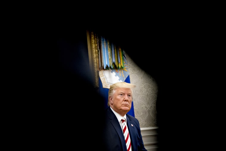 Image: President Donald Trump listens to a question in the Oval Office on Aug. 20, 2019.