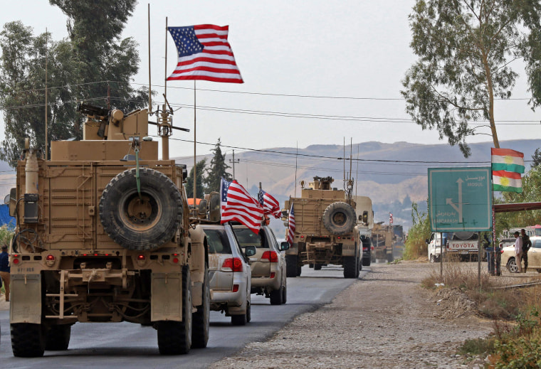 Image: A convoy of U.S. military vehicles arrives near the Iraqi Kurdish town of Bardarash in Dohuk after withdrawing from northern Syria