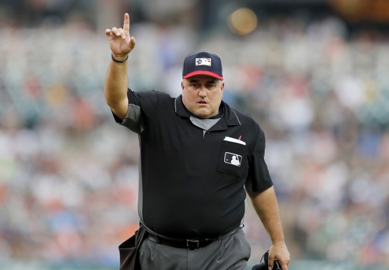 Image: Umpire Eric Cooper signals during a baseball game between the Detroit Tigers and Boston Red Sox in 2019.