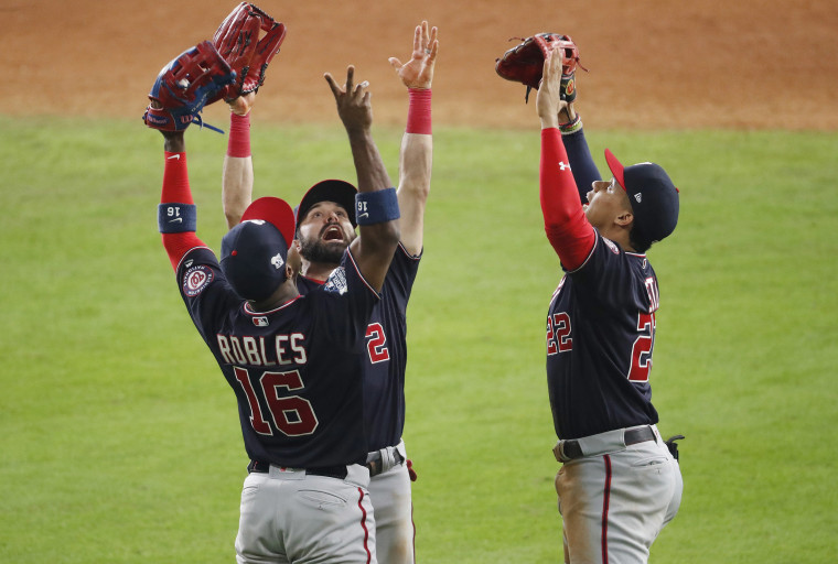 Image: Juan Soto #22, Victor Robles #16 and Adam Eaton #2 of the Washington Nationals celebrate their teams 5-4 win over the Houston Astros in Game One of the 2019 World Series at Minute Maid Park