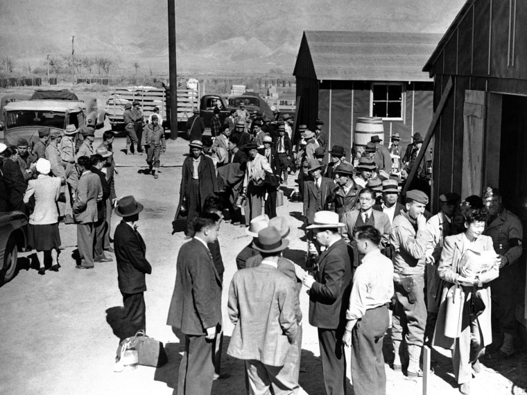 Image: First arrivals at the Japanese evacuee community established in the owens valley at Manzanar, California  March 23, 1942, part of a vanguard of 86 workers from Los Angeles, are assigned to quarters in the barracks.