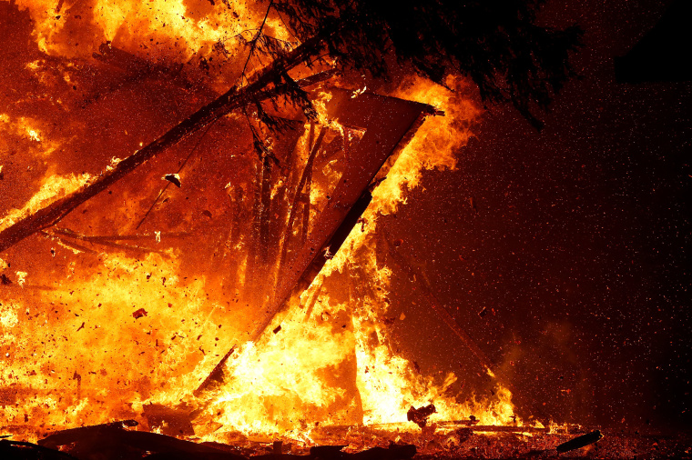 Image: A burning structure collapses during the Kincade fire in Geyserville, California