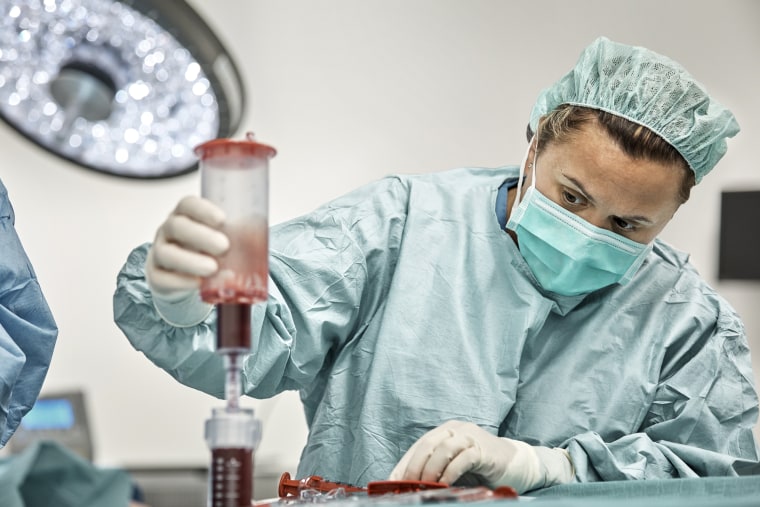 Female doctor during bone marrow transplant procedure
