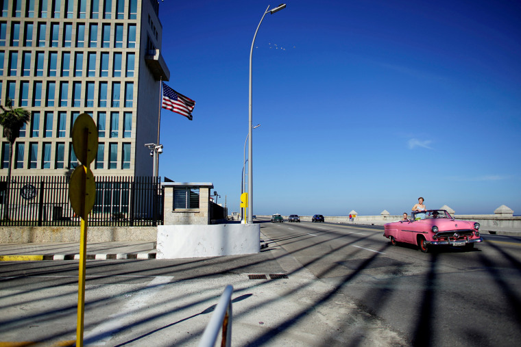 Image: FILE PHOTO: Tourists in a vintage car pass by the U.S. Embassy in Havana